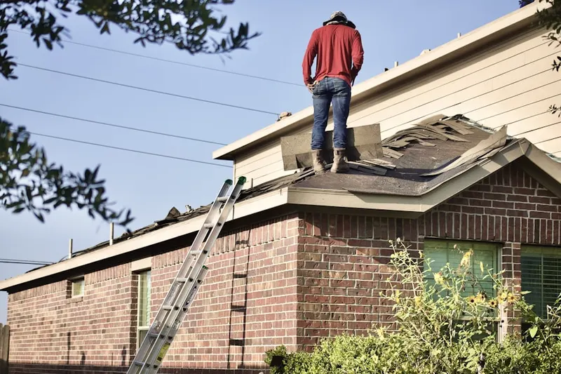 Professional roofer working on a residential roof in Madras